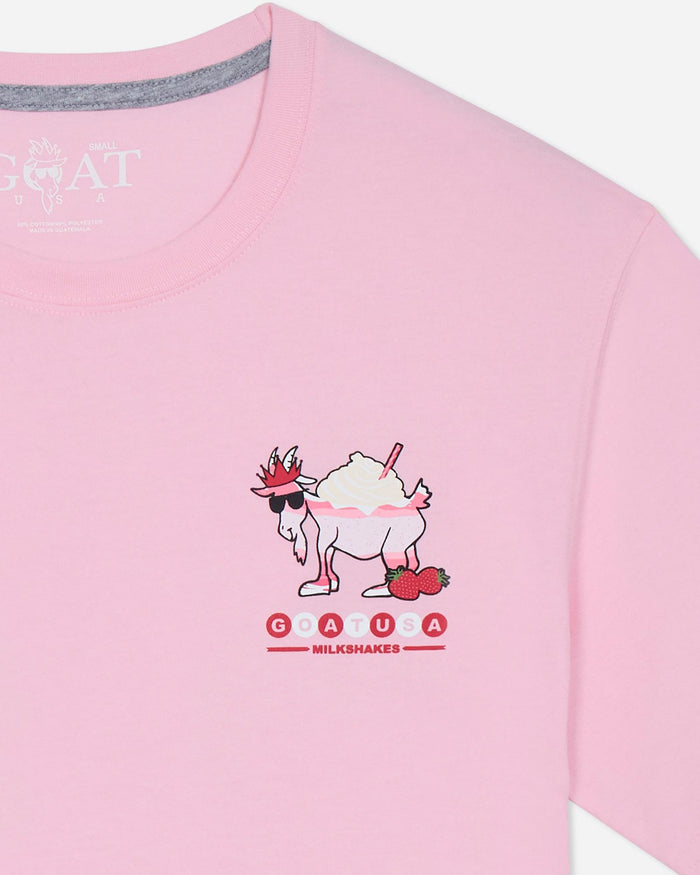 Pink t-shirt with a cartoon goat design and branding on a light gray background.