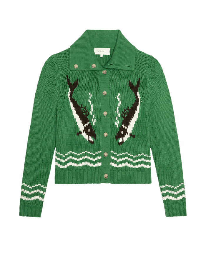 The Bass Cardigan by THE GREAT. SU26 in Grove: a green knit cardigan with collar, featuring two orca whale designs on the front and white wave patterns on the waist and sleeves.