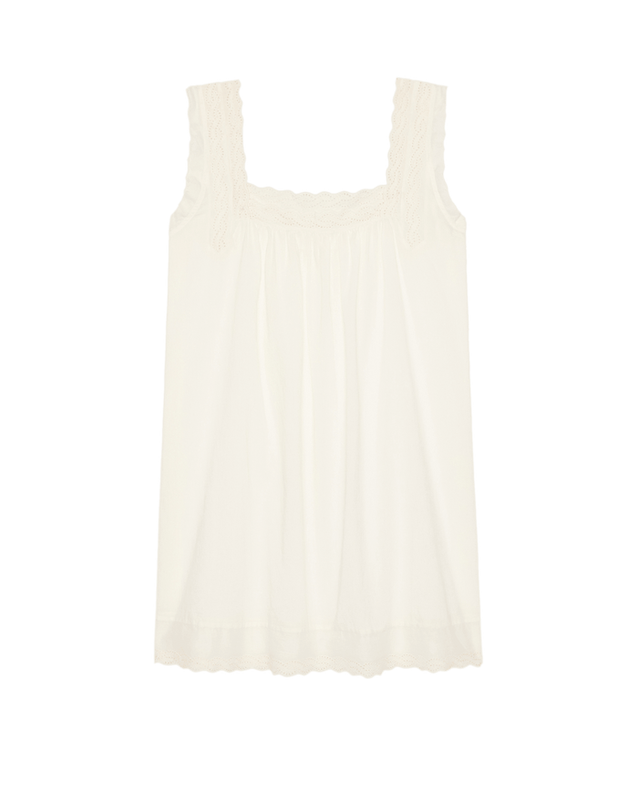 The Eyelet Mini Tank Dress by The Great. SP26 Sleep in True White: A sleeveless white slip dress with lace trim along the square neckline and hem, displayed on a plain white background.