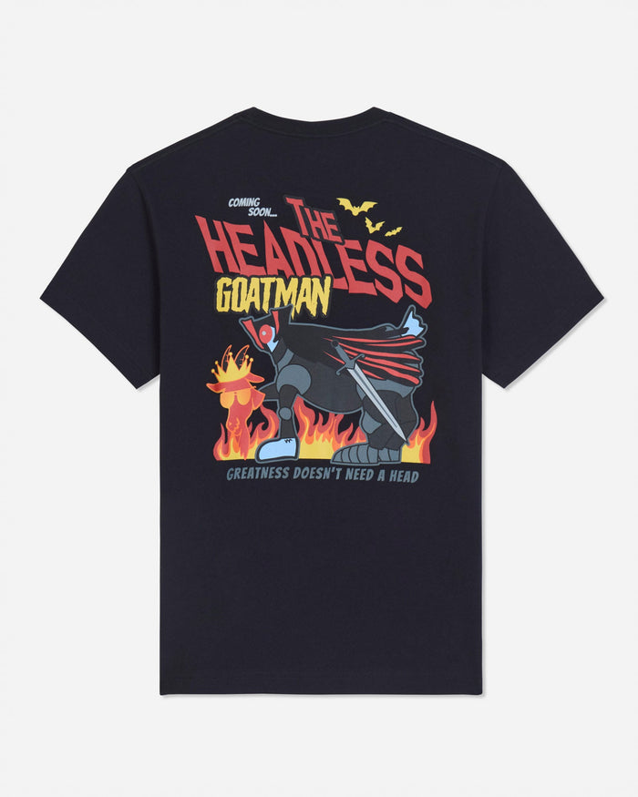 A black short-sleeve t-shirt shown from the back, featuring a large graphic print of Batman with flames and the text 'THE HEADLESS GOATMAN' and 'GREATNESS DOESN'T NEED A HEAD'.