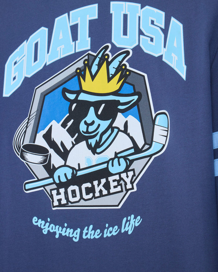 Close-up of a navy blue garment featuring a large 'GOAT USA HOCKEY' graphic with a stylized goat mascot wearing a crown and sunglasses, plus the phrase 'enjoying the ice life' in light blue script.
