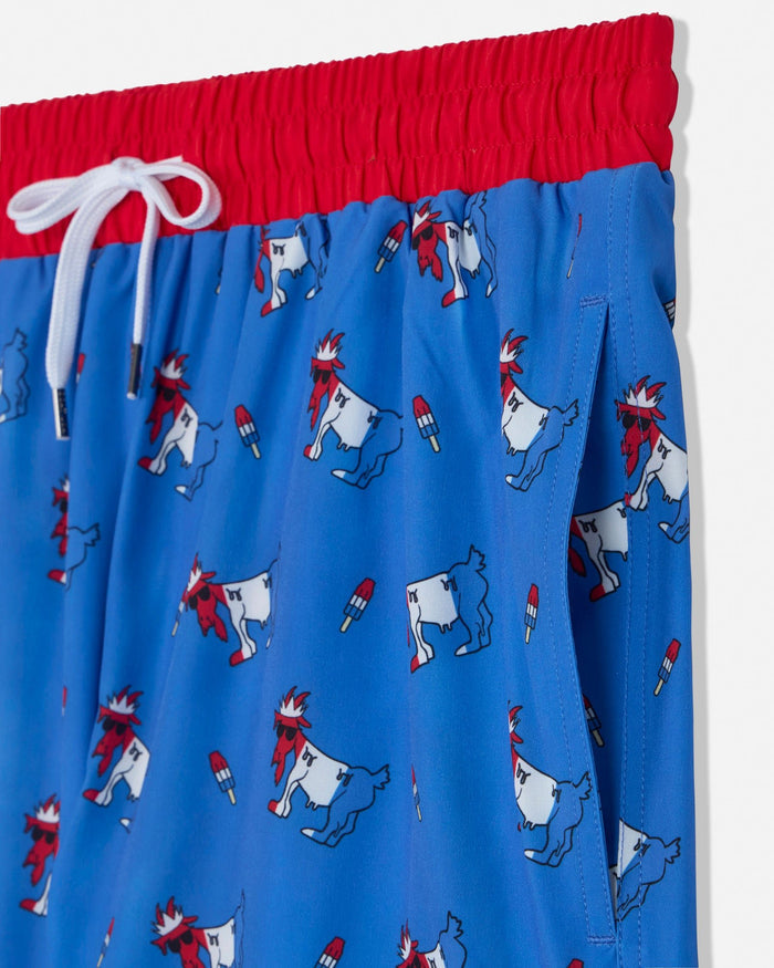Blue swim shorts with red and white accents featuring cartoon goat designs on a white background.
