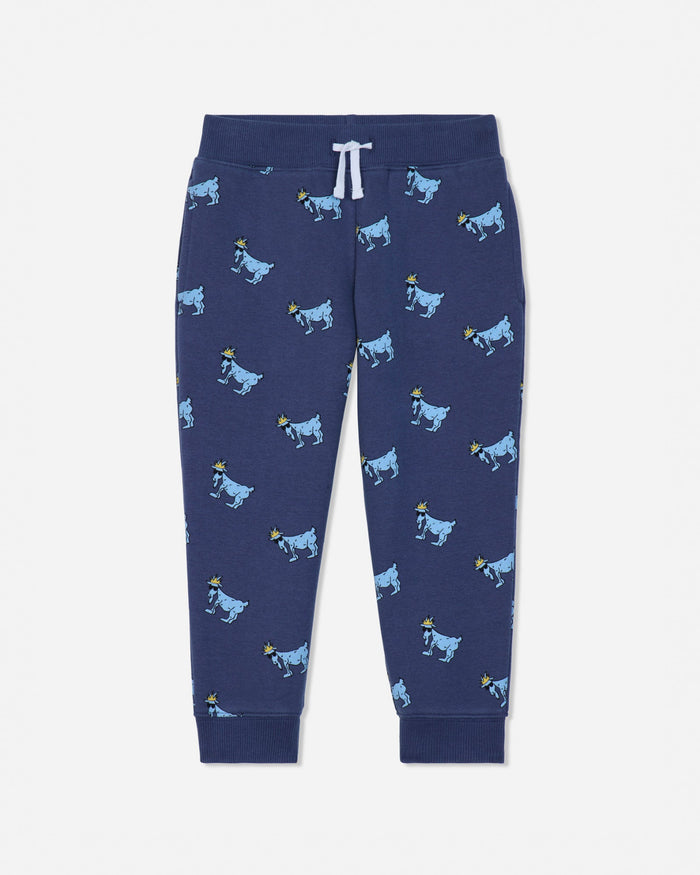 A pair of navy blue jogger pants featuring an all-over print of cartoon cows in light blue and yellow, with a white drawstring at the elastic waistband.#color_navy