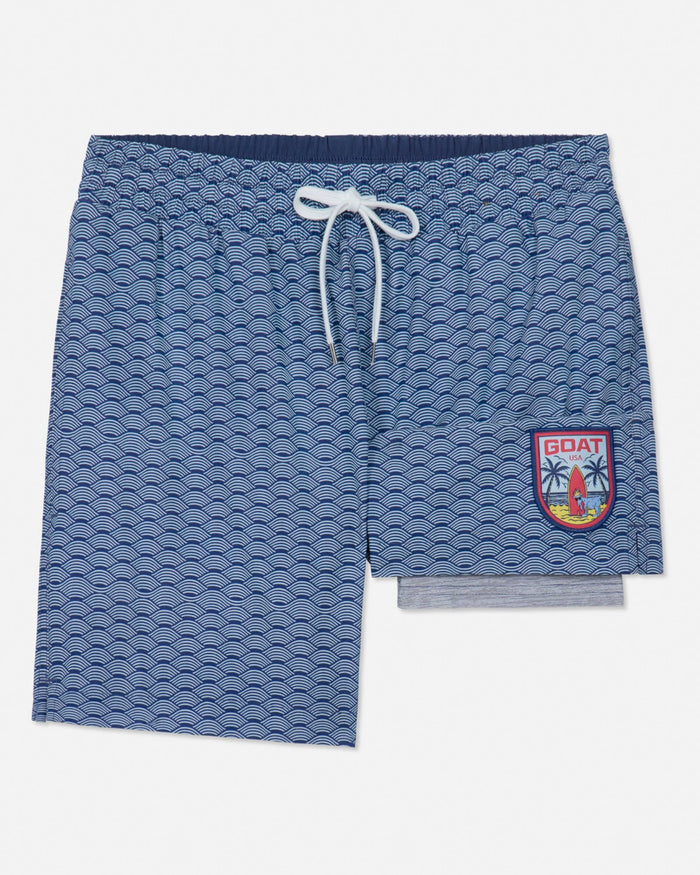 Blue patterned shorts with a logo on a white background