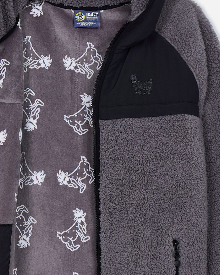 Close-up of a gray fleece jacket with goat pattern and brand label.#color_gray